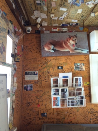 And a view of the walls - more names surrounding postcards for sale and the photo of a red working dog (or dingo?)