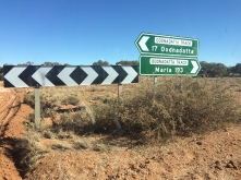 Green distance road-signs: pointing to picture left is "17, Oodnadatta", pointing to picture right is "Marla, 193"