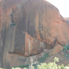 Close-up of the black colours streaking through the red rock of Uluru.