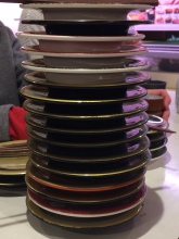 A stack of small plates on a white bench